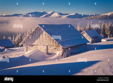 Winter Landscape With Wooden House In The Frost Mountain Village Of