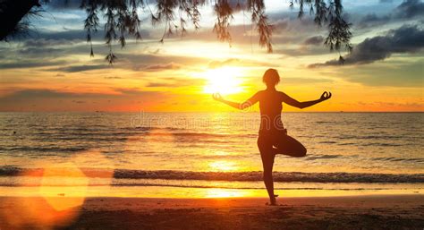 Yoga Woman Silhouette Exercises On The Beach During A