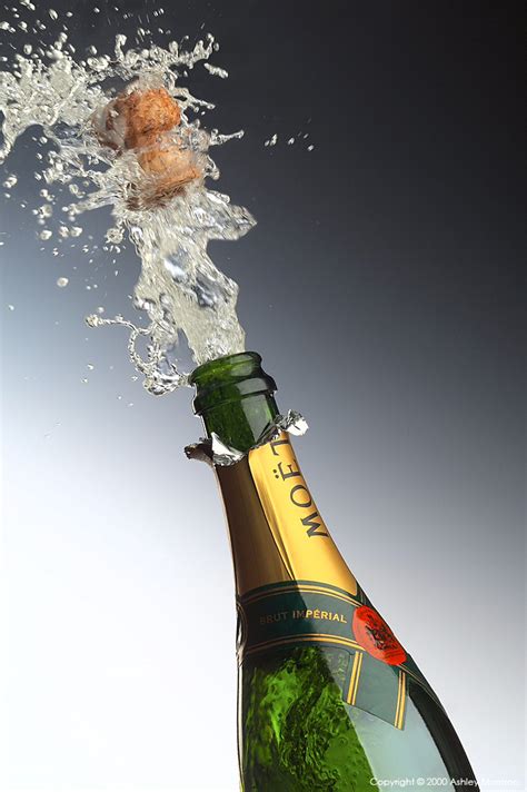 Bottle Of Champagne Popping Its Cork And Splashing