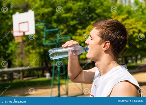 Man Drinking Water From Bottle On Basketball Court Stock Photo Image