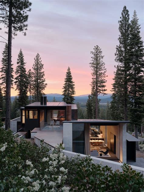 A Beautiful House Surrounded By Volcanic Landscape And Tall Trees