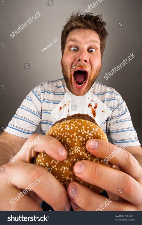 Portrait Of Expressive Fat Man Eating Burger Stock Photo