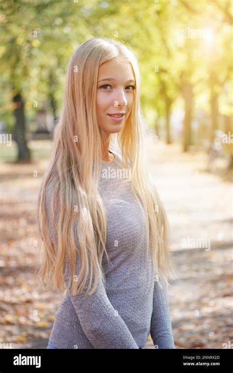 Outdoor Portrait Of Blond Young Woman Enjoying Sunny Day Added Sun Flare Light Leak Filter