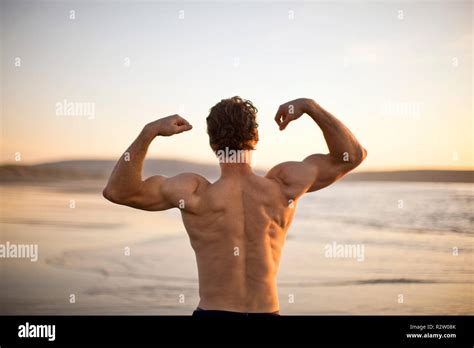 Mature Man Flexing His Muscles On The Beach Stock Photo Alamy