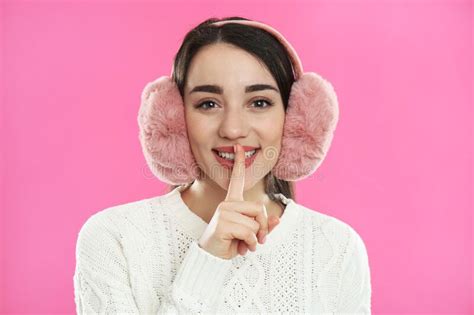 Beautiful Young Woman Wearing Earmuffs On Pink Background Stock Image