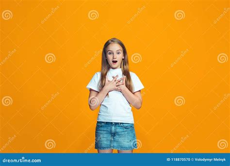 Beautiful Teen Girl Looking Suprised Isolated On Orange Stock Photo