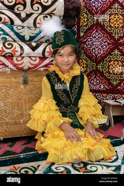 Kazakh Girl In A Beautiful Yellow Dress Inside A Traditional Yurt
