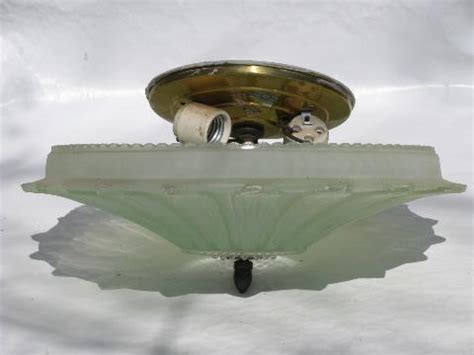 Light bulbs in a dark room. old ceiling light fixture w/ pale green glass flower shade ...