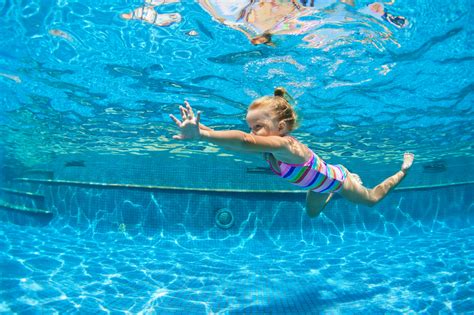 Funny Portrait Of Child Learn Swimming Diving In Blue Pool With Fun