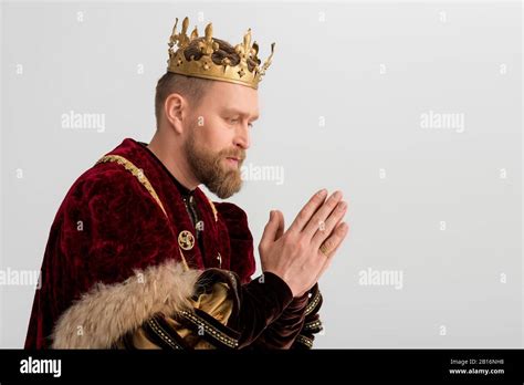 Side View Of King With Crown Praying Isolated On Grey Stock Photo Alamy