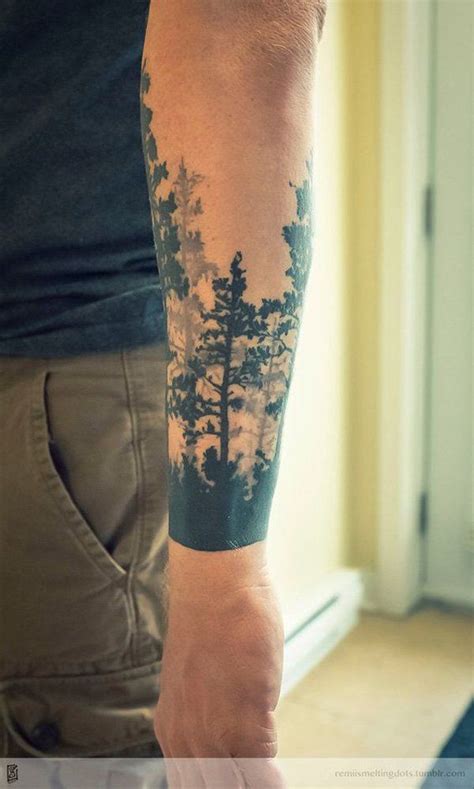 A Man With A Forest Tattoo On His Arm