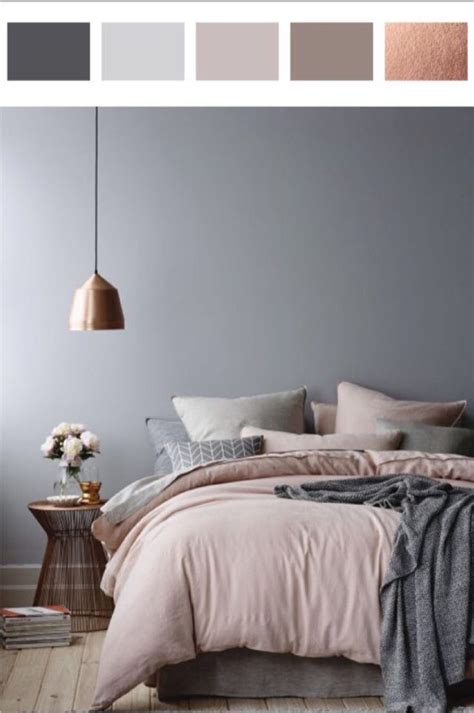 Stunning gold and gray bedroom boasts a gold 4 poster bed accented with gray and white bedding topped with gray and white pillows that complement a wall covered in gray chinoiserie wallpaper. Rose gold, Dusty pinks and grey | Best bedroom colors ...