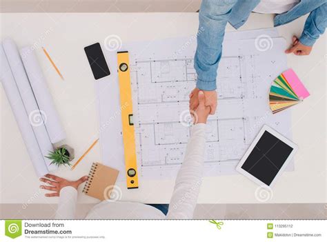 Engineer Or Architect And Businessman Shaking Hands For Teamwork Stock