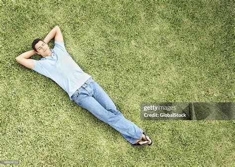 Relaxed Young Man Sleeping On Grass Bildbanksbilder Getty Images