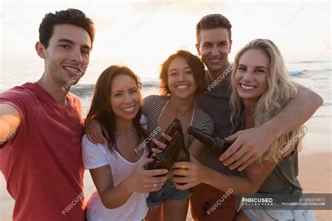 Group Of Happy Friends Standing Together In The Beach Tourist Cheerful Stock Photo
