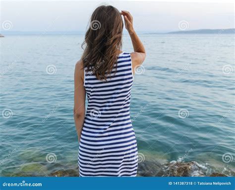 Girl Standing On Shore And Looking At Sea Stock Photo Image Of Full