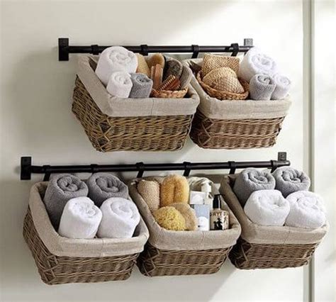 Interior of white modern bathroom with toilet bowl near folding screen, laundry basket, rack and plants. 32+ Creative DIY Towel Storage Ideas & Designs For ...