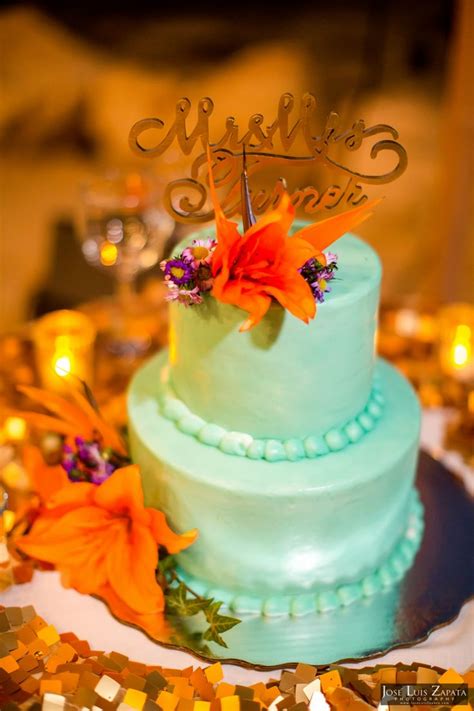 2 Tier Teal Wedding Cake Topped With Tropical Flowers And Handcrafted