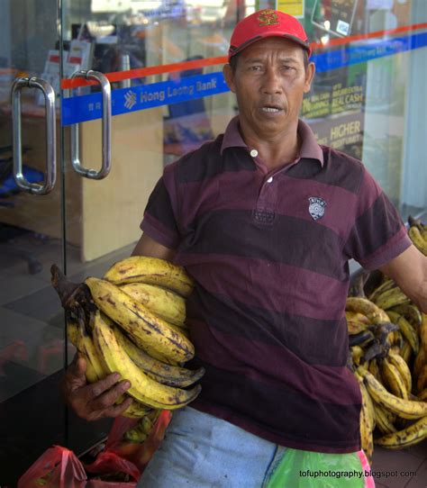 See actions taken by the people who manage and post content. Tofu Photography: Man selling bananas at a market in ...