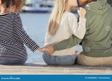 Man Holding Hands With Another Woman Behind His Girlfriend`s Back On