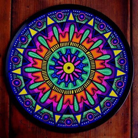 A Colorful Circular Artwork On A Wooden Surface