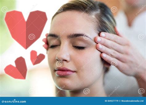 Composite Image Of Woman Receiving Temple Massage With Love Hearts