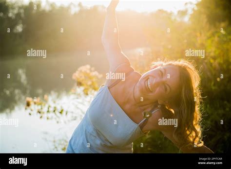 Portrait Of A Beautiful Woman Laughing Hysterically By River Germany