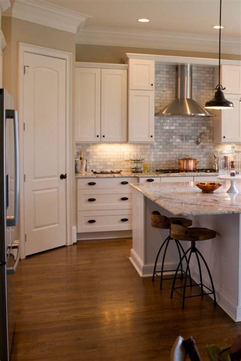 Shaker style kitchen with white cabinetry and black appliances. White Kitchen Cabinets With Black Hardware | Countertopsnews
