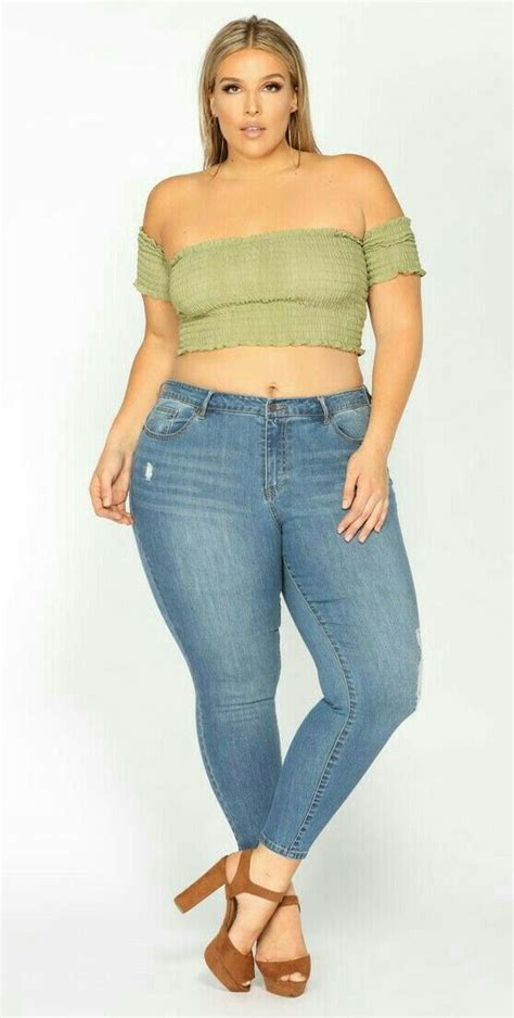 A Plus Size Woman Wearing Jeans And A Cropped Off The Shoulder Top
