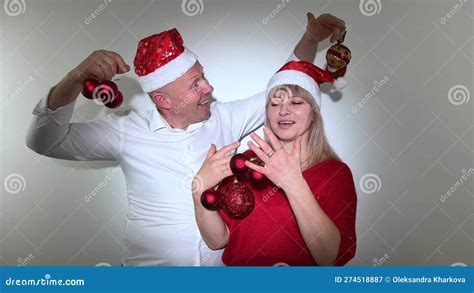 New Year And Christmas Man And Woman Adult Dancing In Their Hands With Toys They Have Christmas