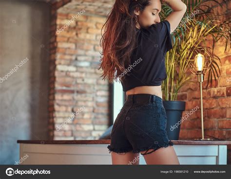 Slim Sexy Girl Showing Her Butt In Black Shorts And T Shirt Posing In