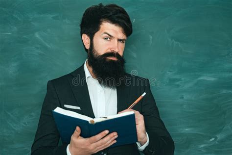 Serious Male Student Studying In School Young Bearded Teacher Near