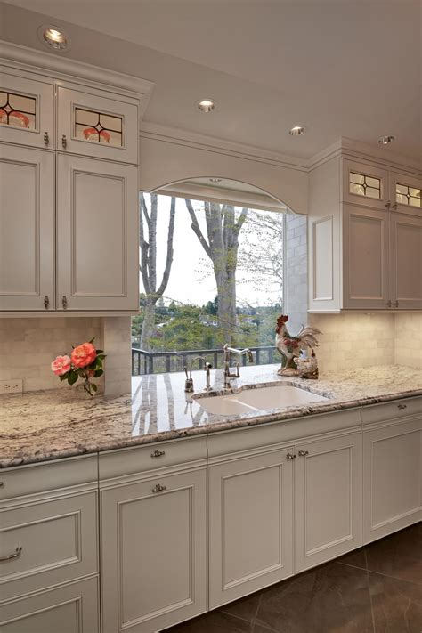 This comprehensive kitchen cabinetry guide details how choosing kitchen cabinets to meet your which style offers more storage options? Light Kitchen with Picture Window and Chic Farmhouse ...