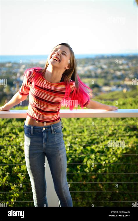 Tween Girl With Pink Hair And Jeans On Outside Balcony Is Overcoming