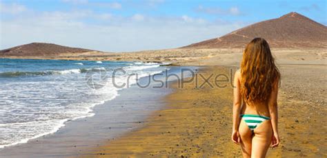 Back View Hot Beautiful Bikini Woman Walking On The Beach Stock Photo