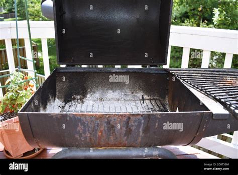 View Of The Open Charcoal Grill After Use With Ashes At The Bottom Of