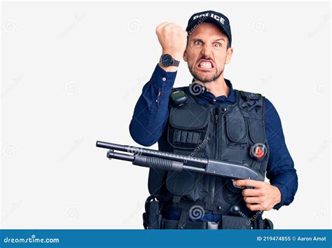 Young Handsome Man Wearing Police Uniform Holding Shotgun Annoyed And