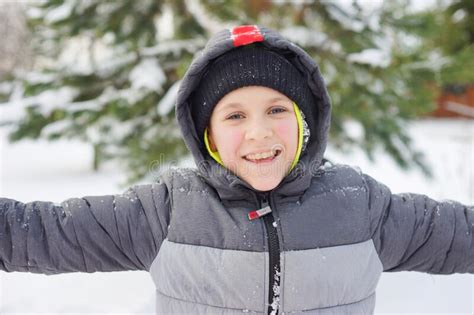 Happy And Smiling Boy Outdoor In Winter Season Snowy Weather Child