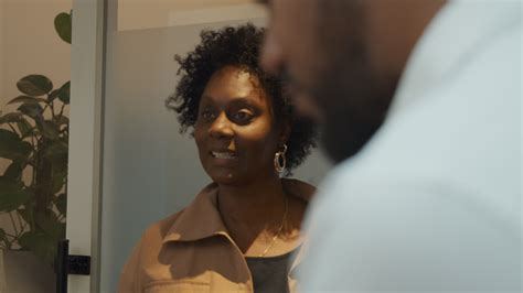 black mature woman talks and looks at tablet held by black man in foreground 2120813 stock