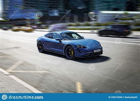 All Electric Car Porsche Taycan In Motion Speeding In City Road
