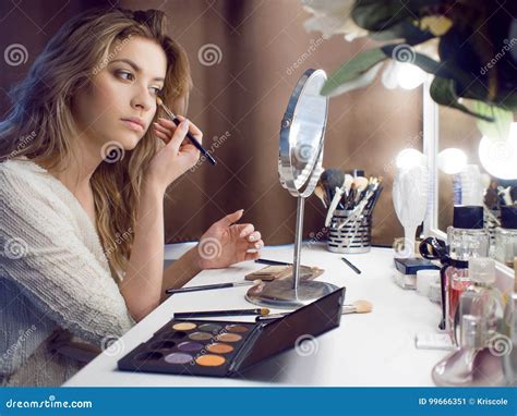 Amazing Young Woman Doing Her Makeup In Front Of Mirror Portrait Of