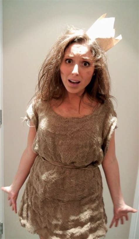 a woman is standing in the bathroom with her hands out and wearing a brown dress