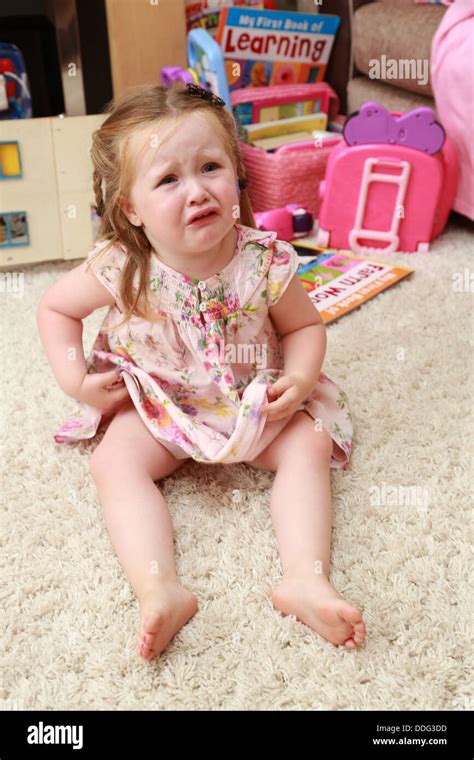 Toddler Sitting On The Floor Crying Stock Photo Alamy
