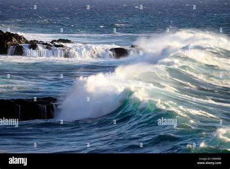 Wave Breaking Rock Stock Photo Alamy