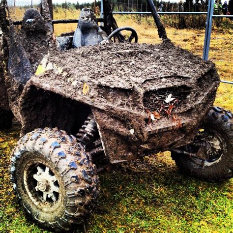 An Off Road Vehicle Covered In Mud And Dirt With Wheels On The Ground