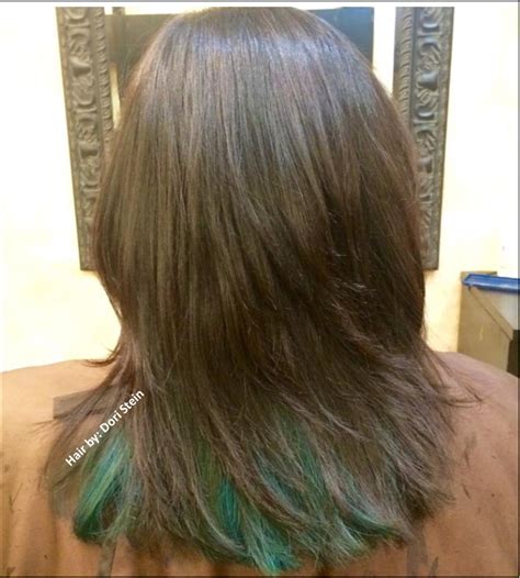 With a rattail comb, pull a section of hair from ear to ear out of the ponytail. dark brown hair with teal/ blue underneath. Blue hair ...