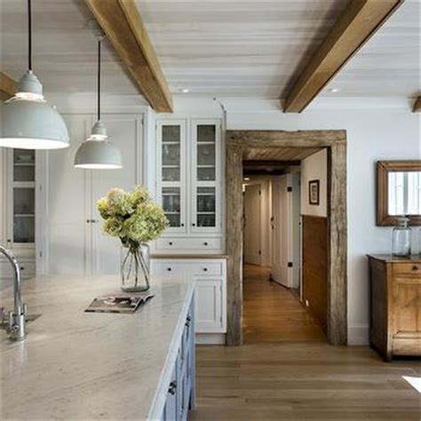 Cottage kitchen with glossy white beadboard ceiling, industrial yoke pendants, white shaker cabinets with black countertops, kitchen island with butcher block countertops, beadboard backsplash and gray washed vintage stools. Kitchen with Beadboard Ceiling - Cottage - kitchen ...