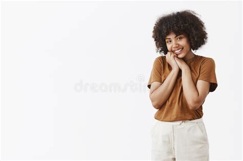 Cute And Touched Silly African American Woman With Curly Hair In Brown