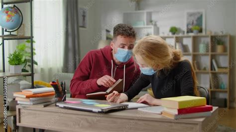 Young Tutor Man Is Studying With A Young Woman At Her Home During