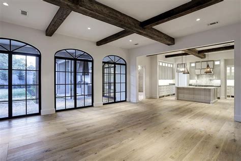 Clean and neat lines are presented by the glass window showing a perfect modern. like this style of open floor plan. love the exposed beams ...